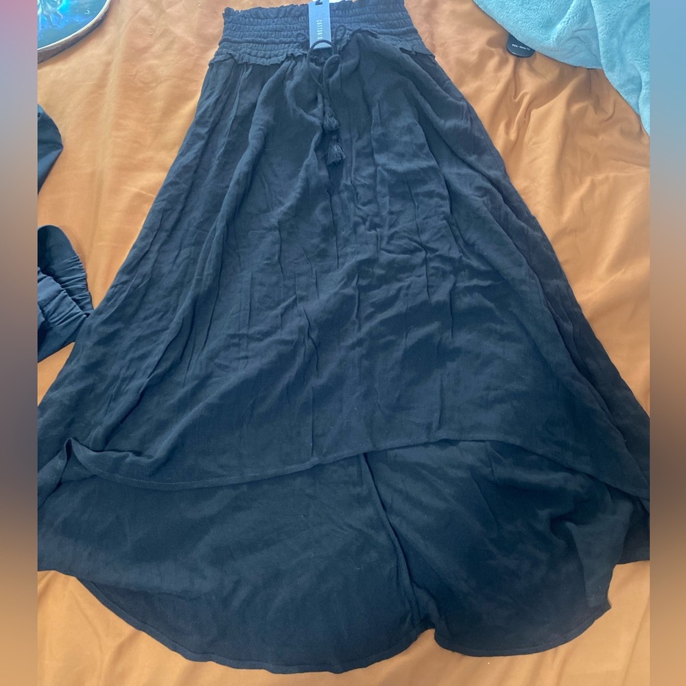 Black high low skirt with tie detail in the front and elastic pleating